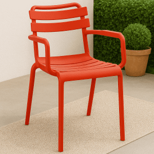 Red bistro plastic chair with armrests placed in a modern outdoor café setup.