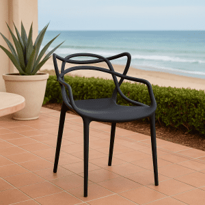 Black bistro plastic chair with a modern artistic backrest in a stylish indoor café setting.