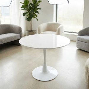 Round white cocktail table with pedestal base in a modern lounge