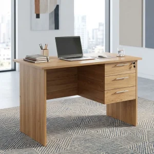 A premium natural teak woodgrain Compact 1m Study Desk featuring a circular white desktop cable grommet and a built-in three-drawer storage pedestal with brushed silver handles and a key lock.