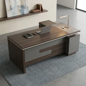 A luxury 1.8m Corporate CEO Office Desk featuring a dark woodgrain top surface, an integrated gray media connectivity hub, matte gray accent panels, and a side storage credenza.