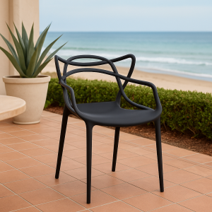 Black bistro plastic chair with a modern artistic backrest in a stylish indoor café setting.