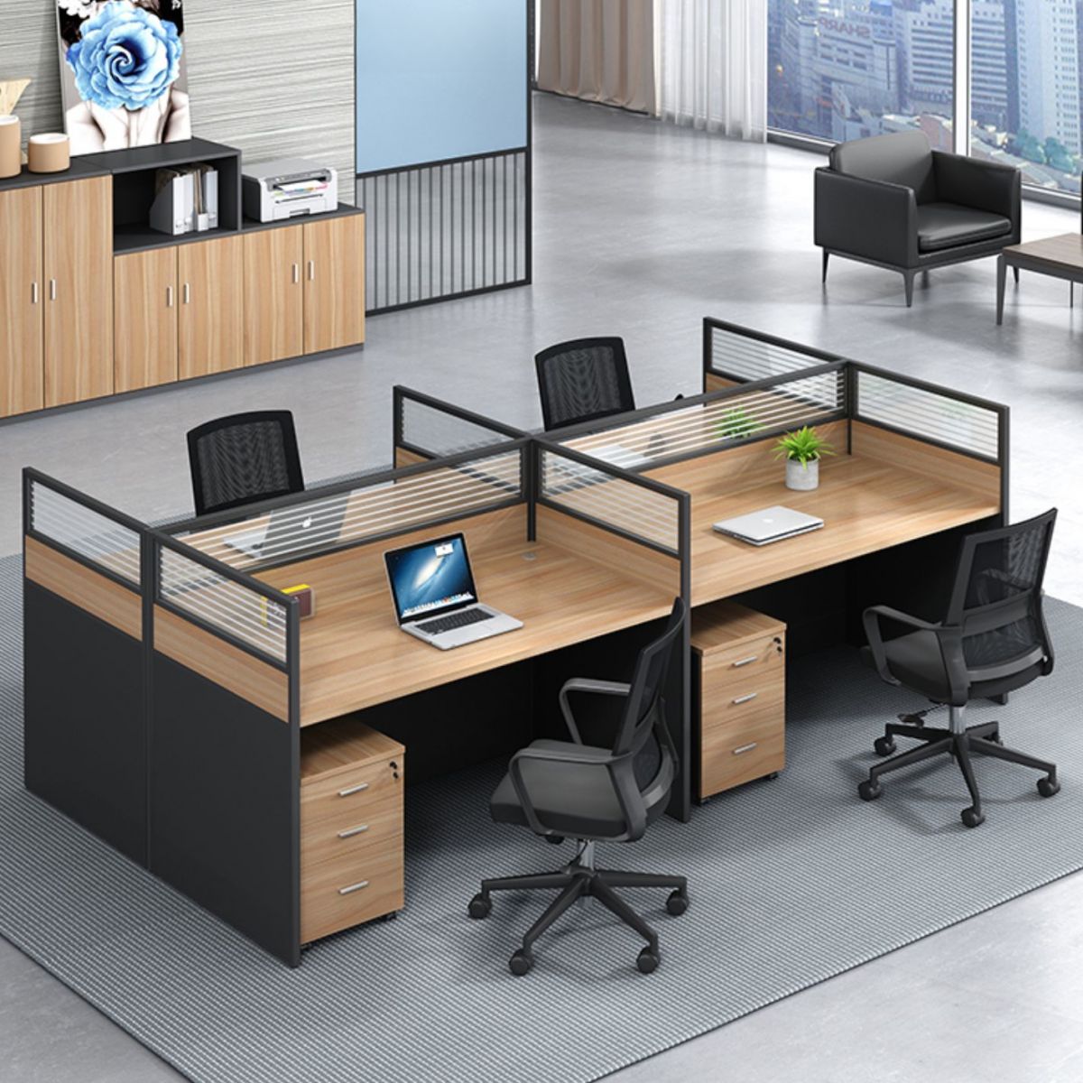 A modern 4-seater office workstation from Pogo Furniture in a bright office, with four people working collaboratively at their desks.