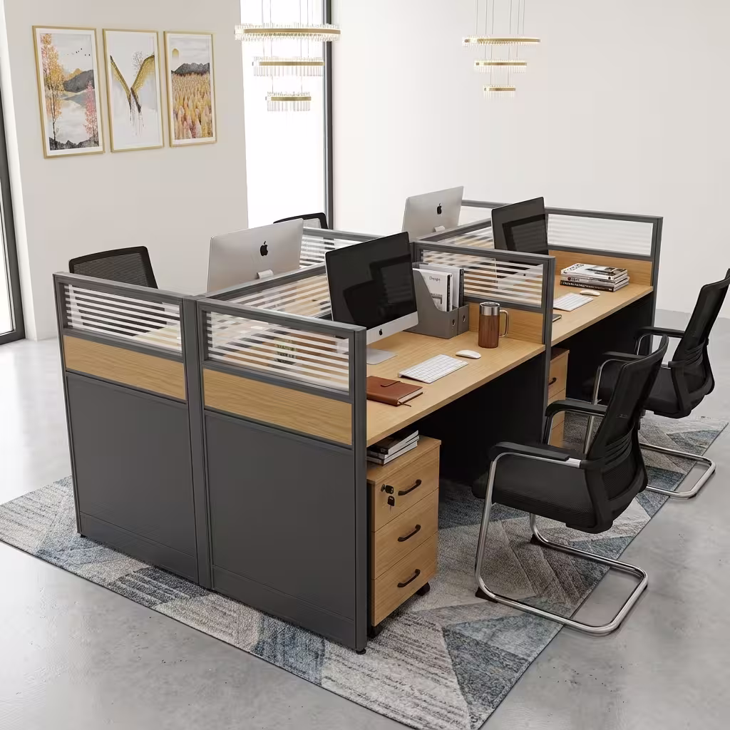 A 4-Seater Office Workstation featuring light oak-laminated desk surfaces, charcoal privacy divider screens with slatted frosted glass tops, and 3-drawer pedestals.