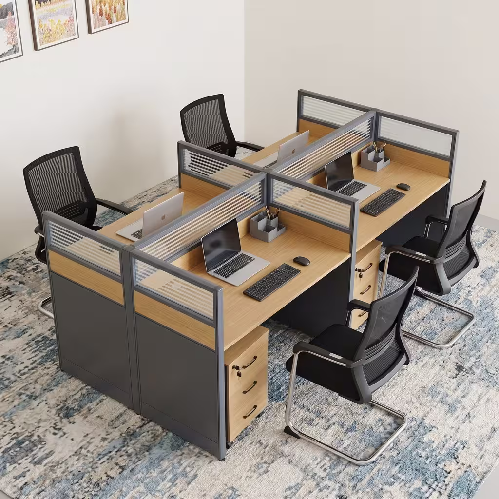 A 4-Seater Office Workstation featuring light oak-laminated desk surfaces, charcoal privacy divider screens with slatted frosted glass tops, and 3-drawer pedestals.