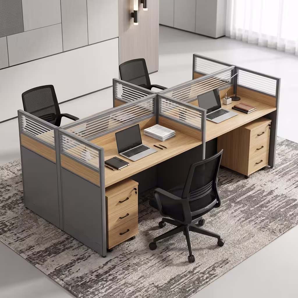 A 4-Seater Office Workstation featuring light oak-laminated desk surfaces, charcoal privacy divider screens with slatted frosted glass tops, and 3-drawer pedestals.