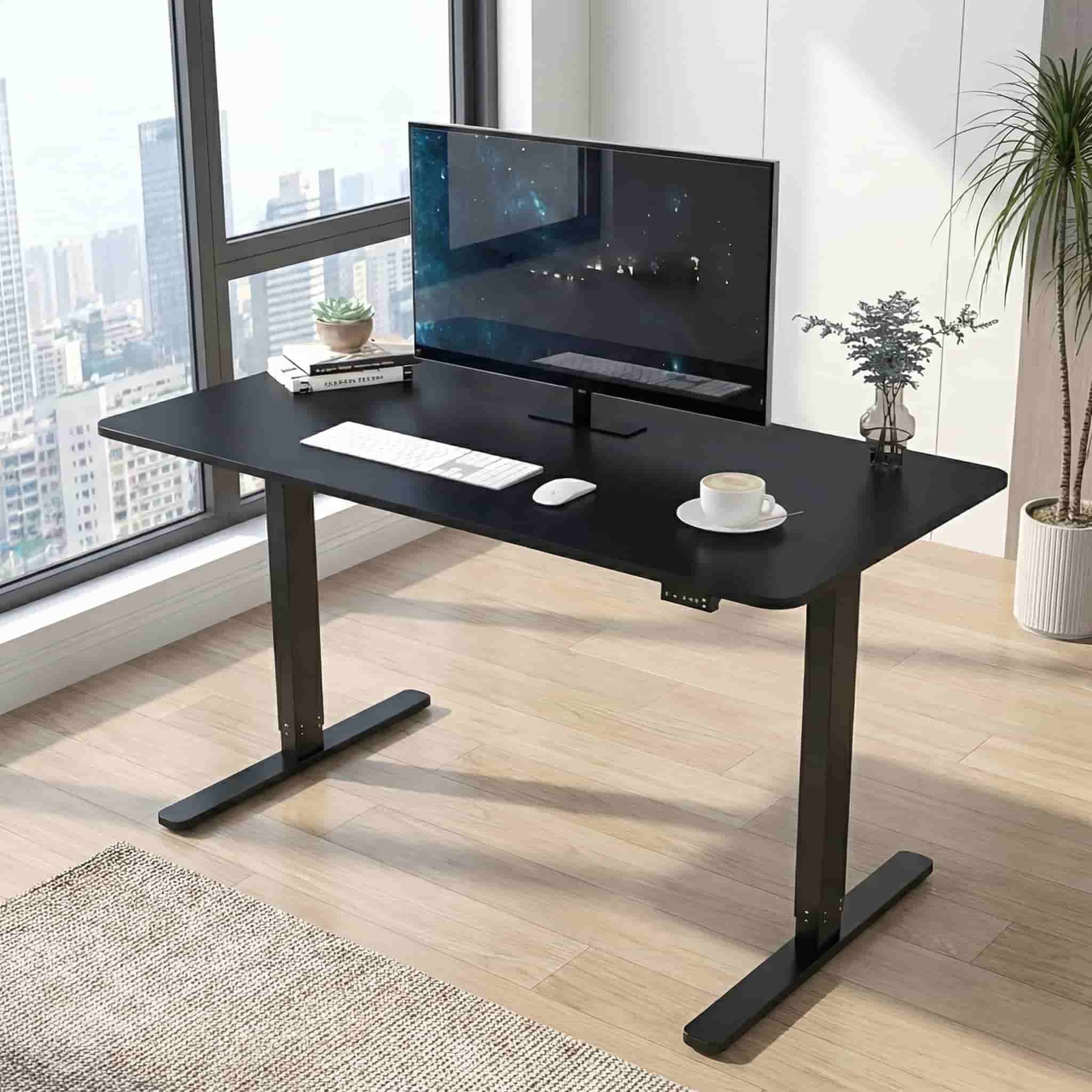 Electric height adjustable standing desk with black tabletop and metal frame