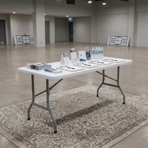 Foldable Multi-Purpose Table with white rectangular fold-in-half tabletop, gray metal folding legs, support braces, and integrated carrying handle.