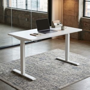 1200mm Electric Standing Desk with rectangular white desktop, electric height-adjustment control panel, white metal T-frame legs and broad feet.