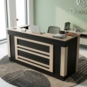 A 2M Reception Desk With Lockable Drawers featuring a light oak wood grain top, a matte black front base, layered geometric paneling, and an integrated return.