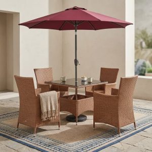 All-weather woven 4-Seater Outdoor Rattan Dining Set with glass-top table and maroon patio umbrella.