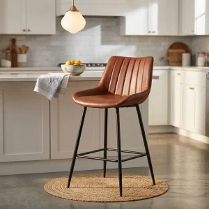 Leatherette Counter Stool with brown padded upholstery, vertical stitched backrest, black four-leg frame and integrated footrest.