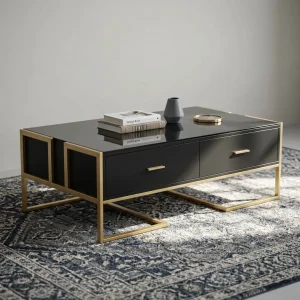 A contemporary rectangular coffee table featuring a high-gloss black tempered glass top, two seamless front drawers with slim gold bar handles, and a geometric open-frame base constructed from brushed gold square metal tubing.