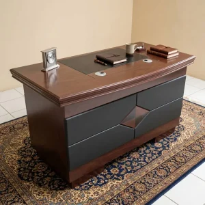A premium 1.2M Classic Mahogany Desk showcasing a rich dark reddish-brown wood grain finish, an integrated black leatherette writing blotter top with silver grommets, a left-side cabinet door, a central keyboard tray, and a right-side three-drawer storage pillar with horizontal silver pulls and a key lock.