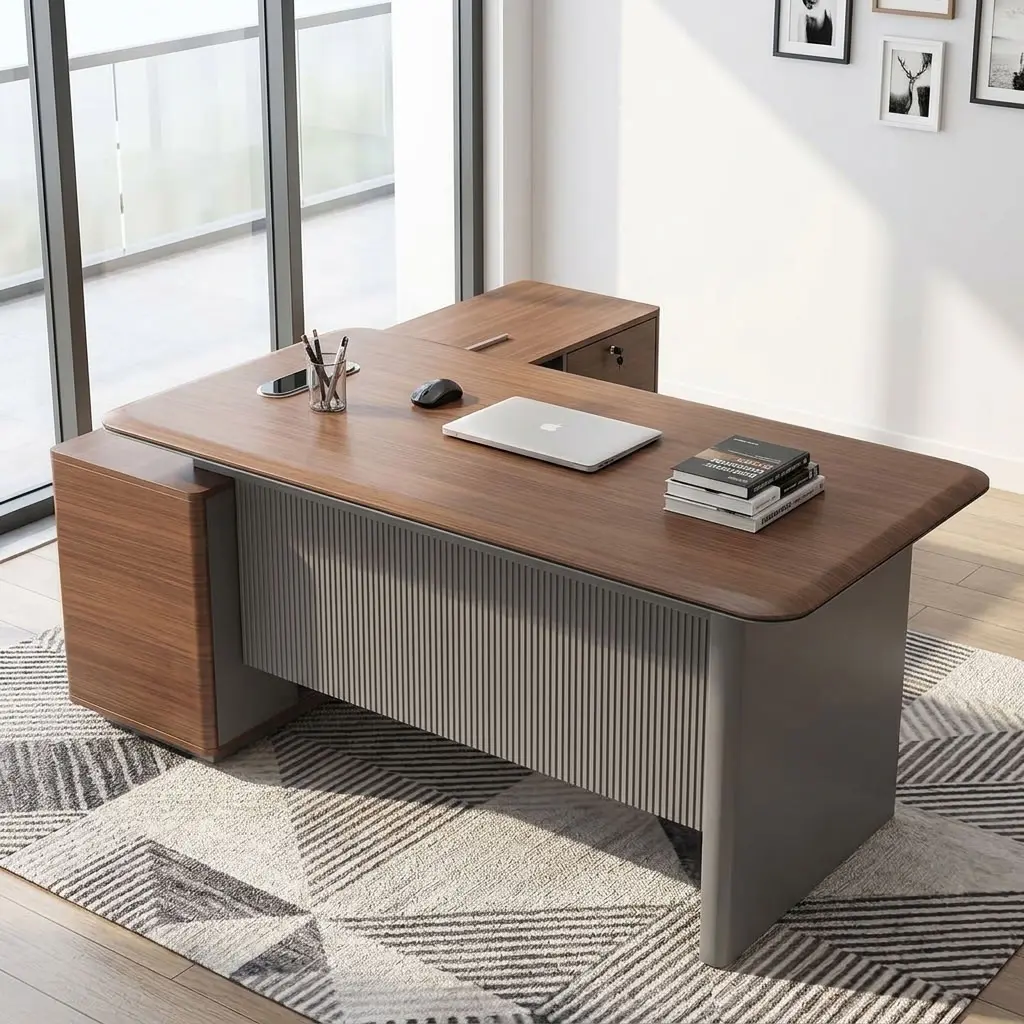 A premium L-shaped 1.6M Corporate CEO Office Desk featuring a thick teak-finished wooden top with curved corners, a prominent charcoal gray fluted front modesty panel, an integrated flip-up silver power grommet, and an attached side storage credenza with two storage drawers and open shelves.