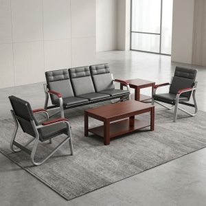 A premium Executive Reception Sofa Set showcasing a matching three-seater bench and two single armchairs, constructed from silver steel sled frames with cushioned black leatherette paneled seats and rich reddish-brown wood armrest accents.