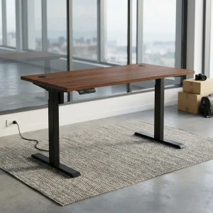 Electric height adjustable desk featuring a rich brown walnut wood grain top, an electronic digital control panel, and dual matte black steel T-legs.